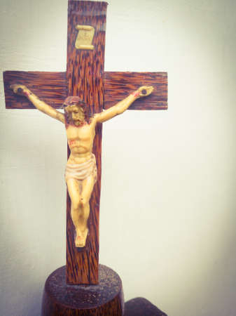 Holy cross with crucified jesus hanging on it is taken from front side.The cross is placed on the focus point.の写真素材