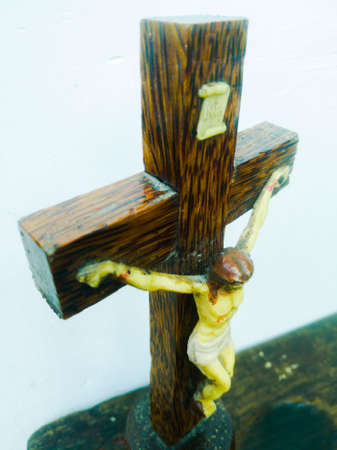 Holy cross in a white background with god jesus hanging on it.The god jesus who got crucified in the cross is shown.の写真素材