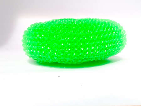 The side view of a plastic dish wash scrubber placed isolated in a white background.The scrubber have green colorの写真素材