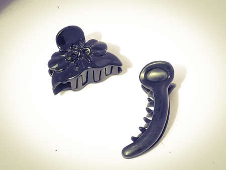 Two claw type hair clips placed isolated in a white background.The clip has black color and have a shining surface under the light.Image has taken from top angle.の写真素材