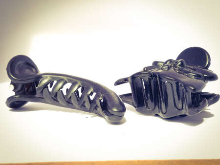Two black hair clips placed isolated in a white background.One is a long type and other is a broad type claw clip.Both are black in color.の写真素材