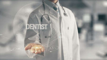 Doctor holding in hand Dentistの写真素材