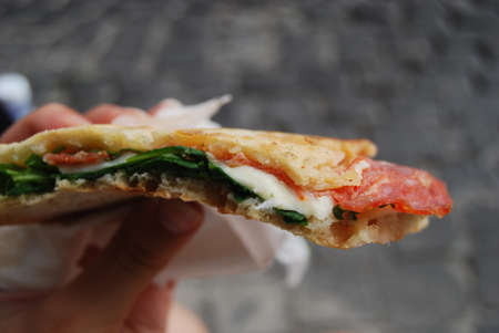 Panini flat bread sandwich with salami and melted cheeseの写真素材