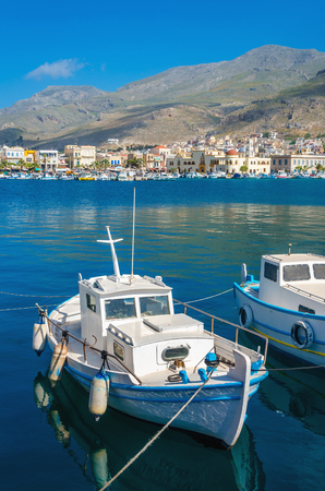Small fishermans boat in Greek blue and white colors in Phothia port of Kalymnos, Greeceの写真素材