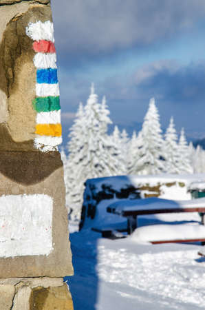 Hiking signs on wall of mountain shelter in winter