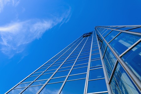 Generic skyscraper over blue sky with some clouds