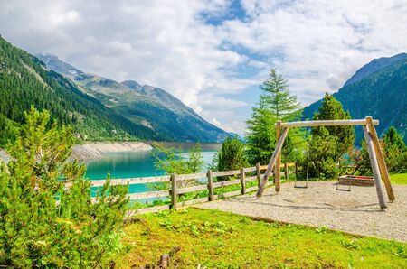 Wooden swing against the azure mountain lake and the Alps, Austriaの写真素材