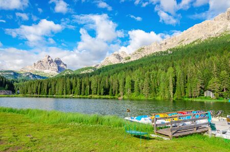 View on peaceful lake with padal boat pier and Tre Cime in background from Misurina village, Sexten Dolomites, Italyの写真素材