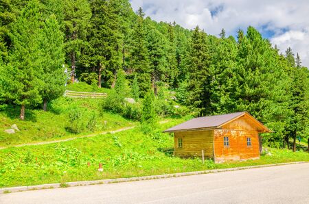 Wooden cabin on a background of green pines, Austria, Alpsのeditorial素材