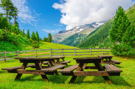 Wooden benches for visitors to picnic, beautiful views of the Alpine valley, Austria, Alpsの写真素材
