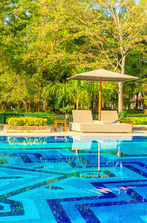 Romantic view of two sunbeds at the swimming poolのeditorial素材