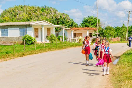 VINALES, CUBA - DECEMBER 12, 2013: Children in school uniforms come back from school, Vinales, Cubaのeditorial素材