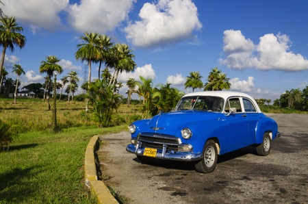 HAVANA, CUBA - DECEMBER 2, 2013: Classic American blue car one of streets in Havana, where old cars bought before Cuban revolution are icon view of Cubaのeditorial素材