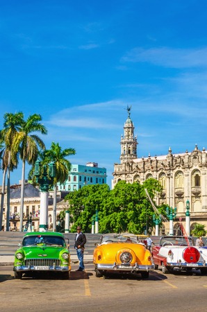 HAVANA, CUBA - DECEMBER 2, 2013: Classic American colorful cars one of streets in Havana, where old cars bought before Cuban revolution are icon view of Cubaのeditorial素材