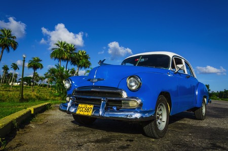 HAVANA, CUBA - DECEMBER 2, 2013: Blue classic American car on one of the streets of Havana, where old cars are relic of Cuban revolution and still attracts many tourists.のeditorial素材