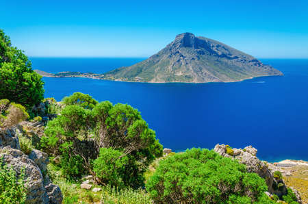 Amazing view on Greek volcano Island with green bushes in foreground, Greeceの写真素材