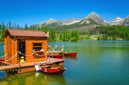 Wooden hut and red boatson the mountain lake Strbske pleso in National Park High Tatra, Slovakia, Europeの写真素材