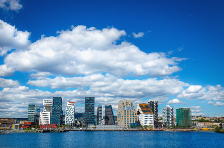 OSLO, NORWAY - 21 JUNE, 2015: Amazing view of modern business architecture in the center of Oslo on a background of blue sky and blue waters of the Oslo Fjord, Norwayのeditorial素材