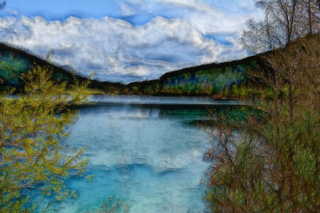 A lake under a cloudy sky  Painterly landscape の写真素材