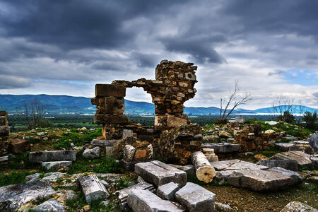 Pillar ruins at Ancient Troizina at dramatic sky, Peloponnese, Greeceの写真素材