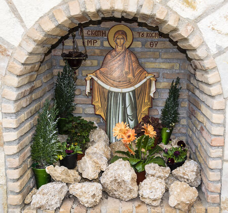 A picture of Virgin Mary with rocks and flowersの写真素材