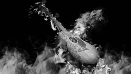 Acoustic classical guitar in smoke on black backgroundの写真素材