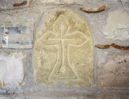 Ancient greek cross on the stone wall. Backgroundの写真素材