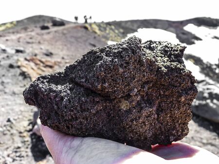 Volcanic rock in human hand at mount Etna, Sicily, Italyの写真素材