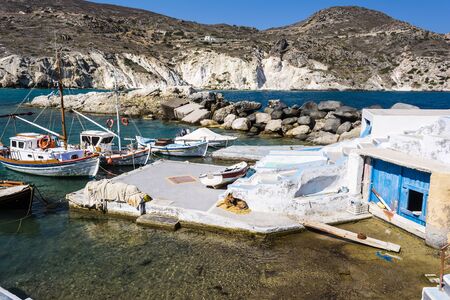 Mandrakia traditional Greek village with sirmate  - fish boats and a dog at Milos island, Greece.の写真素材