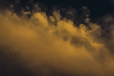 Dramatic yellow cloudscape with sunsetの写真素材