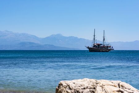 PETALIDI, GREECE - AUGUST 13, 2017: Tourists enjoying sea journey on vintage sail ship in Petalidi village, Greeceのeditorial素材