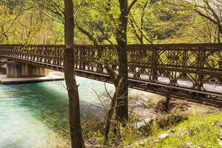 A metallic bridge across a mountain river.の写真素材
