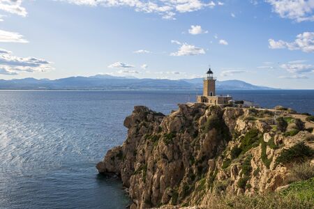 Cape Melagkavi Lighthouse also known as Cape Ireon Light on a headland overlooking eastern Gulf of Corinth, Greece.の写真素材