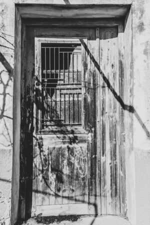 Old wooden door of traditional house in the village Chamaitoulo, Crete, Greece.の写真素材