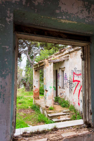 Window view of an abandoned old villa at Pallini, Greeceのeditorial素材