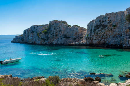 People swimming in the clear blue waters of Proti Island, near Marathopoli, Messinia at Peloponnese.