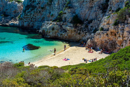 Marathopoli, Greece - August29, 2019: People swimming in the clear blue waters of Proti Island, near Marathopoli, Messinia at Peloponnese. The name of the island derives from the ancient sea god Proteus, son of Poseidon.のeditorial素材