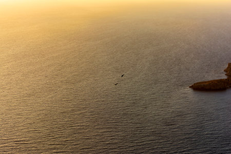 Surface water background of the ocean at sunset with a golden light tone.の写真素材