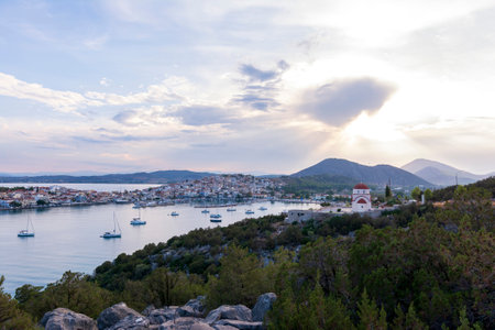Beautiful view of Ermioni sea lagoon with moored yachts and boats at sunset time. Travel by Greece.