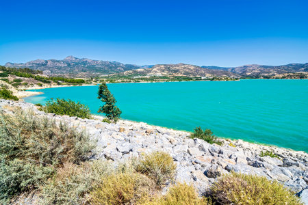 Bramian Lake in Ierapetra, Crete, Greece. The artificial Bramian Lake was built in 1986 to cover the cultivation needs of 30,000 acres of Ierapetra. The lake has an area of 1050 acres and a capacity of 15 million cubic meters, making it the third-largest wetland in Southern Greece.の写真素材