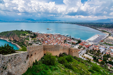 View from Palamidi on Nafplio city in Greece with port, Bourtzi fortress, and blue Mediterranean sea. Cloudy day.の写真素材