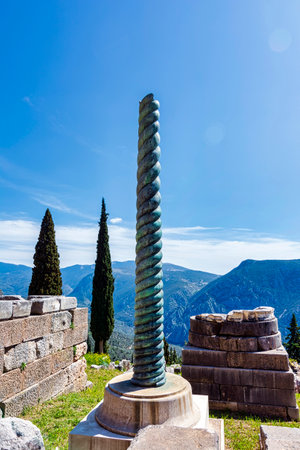 Serpent Column of Plataea or Delphi Tripod in front of the Temple of Apollo in Delphi, Greece, an ancient sanctuaryの写真素材