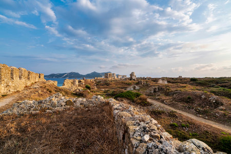 A view of the ancient arched hall and defensive walls at Methoni Fortress, highlighting Venetian architecture and coastal surroundings.の写真素材