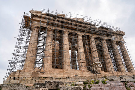 Frontal view of the Parthenon temple on the Acropolis in Athens, fully surrounded by scaffolding as part of ongoing preservation work.の写真素材