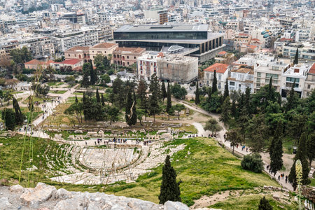 Elevated view of the ancient Theatre of Dionysus nestled below the Acropolis, with the modern...