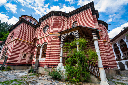 Close view of the striped exterior walls and ornate entrance of Rila Monastery in Bulgaria, a UNESCO World Heritage Site surrounded by the Rila Mountains.の写真素材