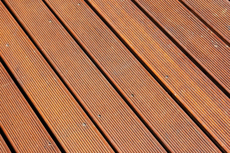 A brown background of a clean and tidy wooden floor on a terrace outdoors for decoration の写真素材