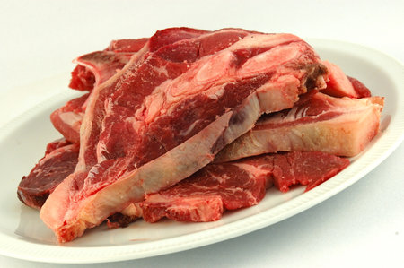 A bulk of delicious fresh raw juicy South African beef meat on a plate isolated on white backgroundの写真素材