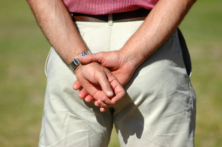 Two white crossed male hands of a caucasian patient referee man standing in the park and waiting for... の写真素材