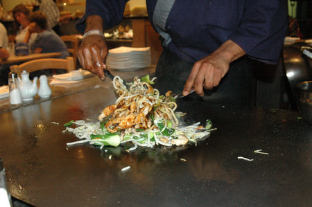 Hands of chef cook preparing Japanese food on Tepanyaki table in a upmarket restaurant の写真素材